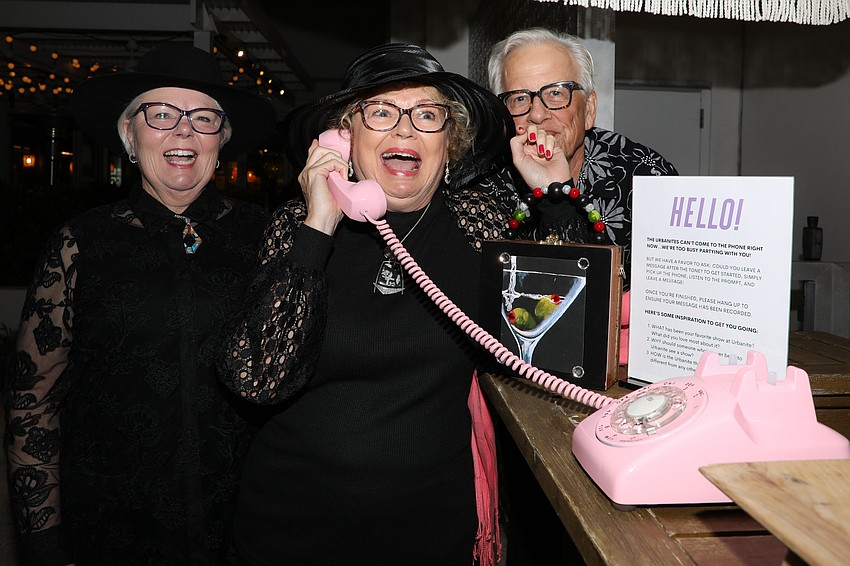 Lynn Blackledge, Elsa Rohow and Rod Joslin play telephone at the Urbanite Theatre Black Party held at the Sarasota Modern.