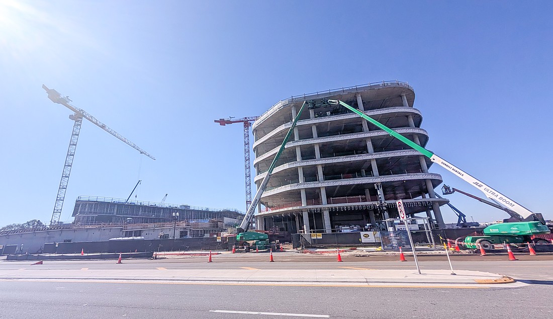 The Four Seasons Hotel & Residences, left, and One Shipyards Place, the six-story future headquarters of the Jacksonville Jaguars are under construction March 12 south of EverBank Stadium.