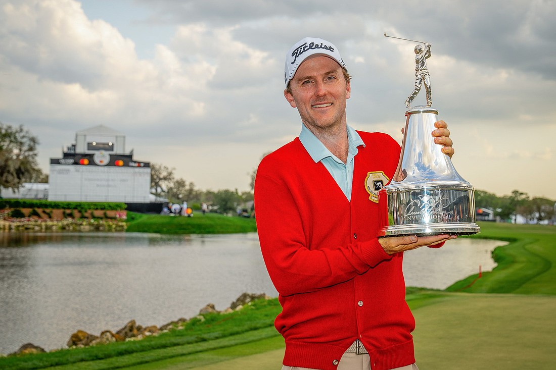 Russell Henley donned Arnold Palmer’s famous red cardigan following his first API win.