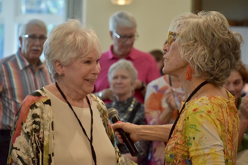 Marci Weisgold accepts the first place prize from Deborah Van Brunt for her cold cast bronze sculpture, 