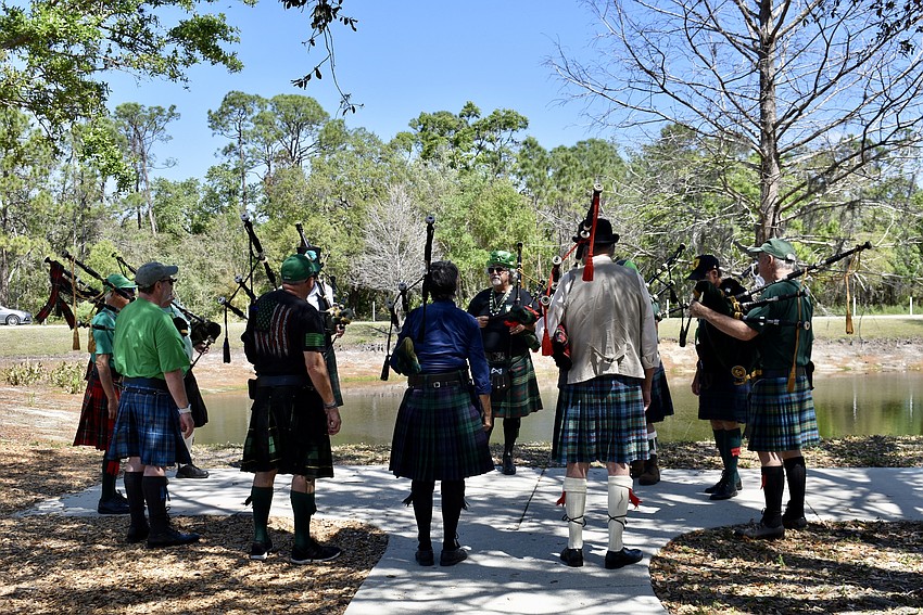 Members of Lion Rampant Pipe and Drum gather for a last-minute practice session before the Lucky Dog Parade.