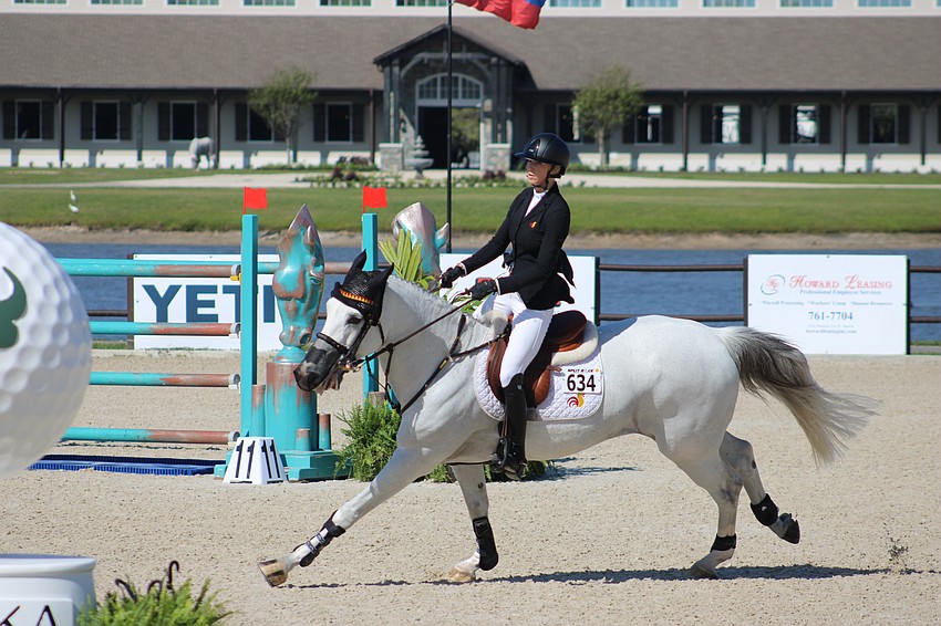 Isabel Coxe of the U.S. and Incredible Bleu go into another series of jumps during the Split Rock Jumping Tour Finale at TerraNova on Saturday.