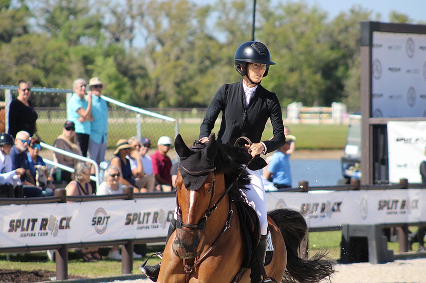 Bliss Heers aboard Petit makes a turn to begin the jumps in front of the pavilion at the Split Rock Jumping Tour Finale at TerraNova.