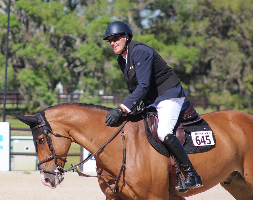 Ireland's Paul O'Shea gives Spy a congratulatory pat after a clean run in the Split Rock Jumping Tour Finale at TerraNova Saturday. O'Shea won the championship of the $100,000 event.