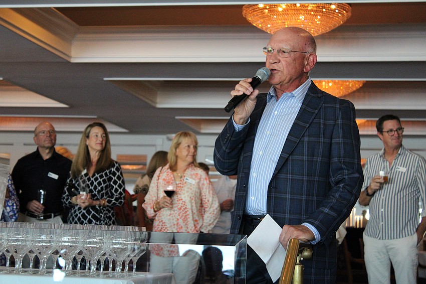 Bird Key Yacht Club Commodore Michael Landis welcomes attendees to a celebration of the club house's final month before demolition and reconstruction.