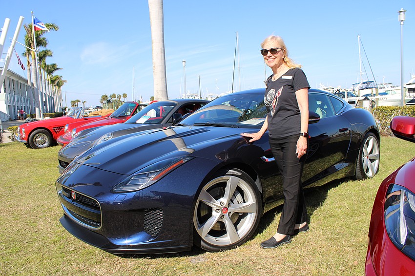 Jan Anderson, who has been a member of the Sarasota Yacht Club for 31 years, brings her 2018 Jaguar, pointing out the elegant lines of the car's design.