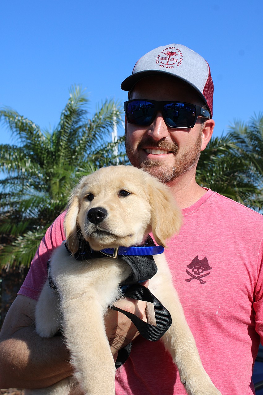 10-week-old Odie and owner Luke Lapham, visiting from the Clearwater Yacht Club, give the YachtRodder car show two paws up.