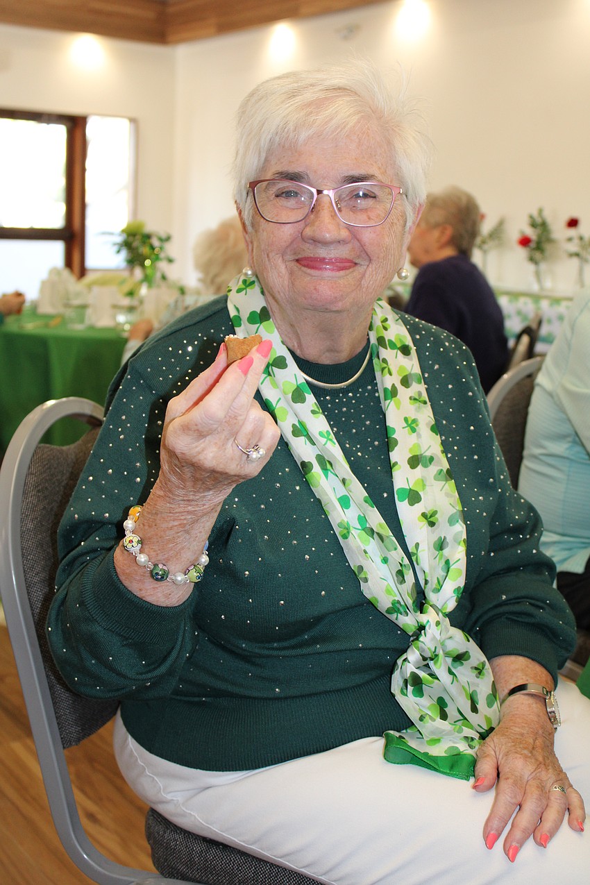 Irishwoman Ellen Roderick enjoys a potato at the dinner and concert held March 17 at All Angels by the Sea Episcopal Church.