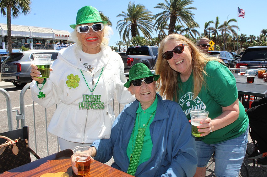 Genny Resch, visiting from Maryland to see the Orioles play, makes friends with Bill Oludwig and Cha Cha Sunshine at Lynches Pub & Grub on Saint Patrick's Day.