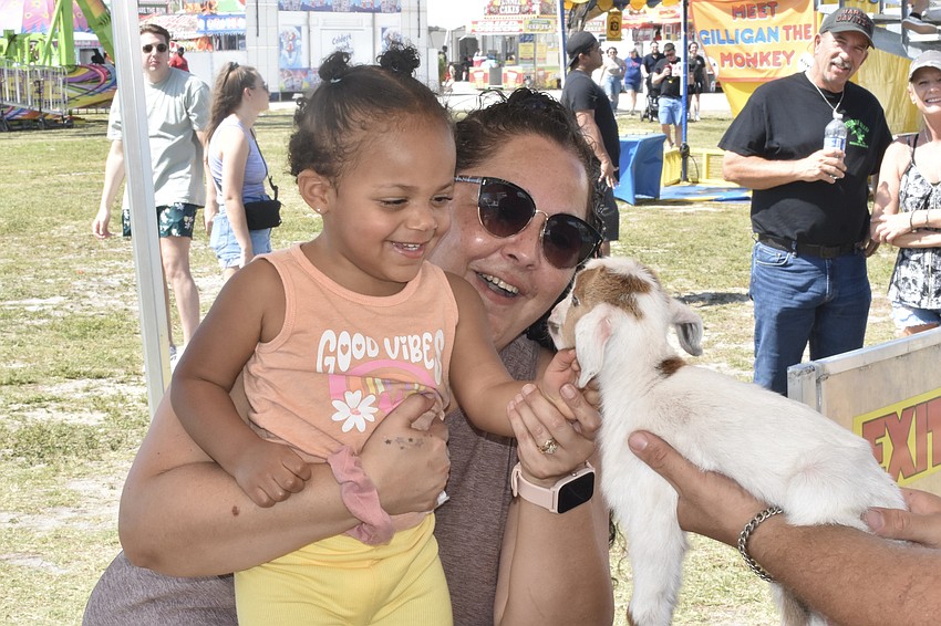 Aralynn Santos-Meyer, 2, and her mom Rhiannon Santos-Meyer meet Jimmy the goat.