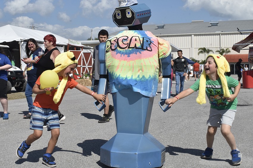 Luca Passalacqua, 7, and Emmitt Questel, 8, meet Oscar the robot.