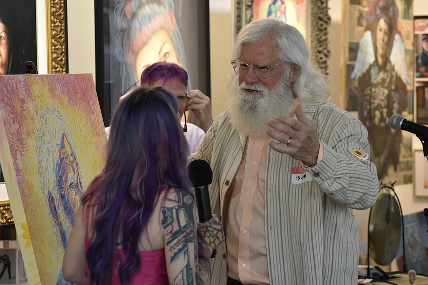 Megan Howell receives Bubba Henson's thanks as he receives the portrait of himself.