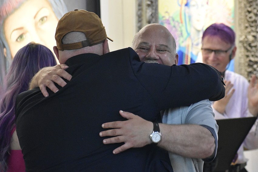 Nick Rentschler hugs his friend and fellow resident Ritchie Mood.