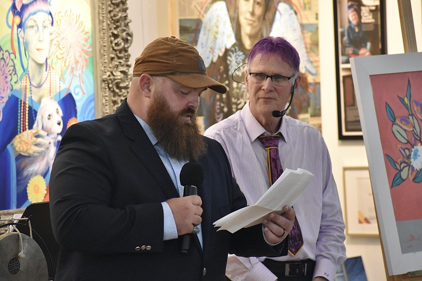 Nick Rentschler offers a speech as Paul Sykes looks on.