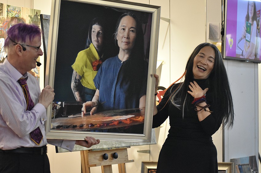 Paul Sykes presents a framed photo print of Li Jian Volk painting Megan Howell.
