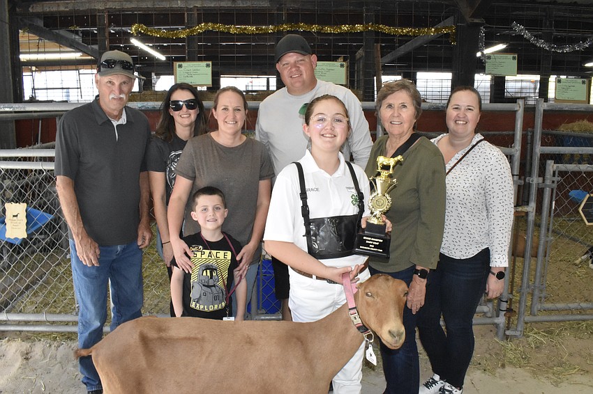Fifth grader Grace Welden (front), won the grand champion dairy goat award. She is pictured here with her goat Paddy Whack and three generations of family members involved in agriculture: her grandfather Chuck Johnston, aunt Sarah Herlihy, brother Eli Welden, 5, mother Katie Johnston, father JR Welden, grandmother Peggy Johnston and aunt Jessica Duncan.