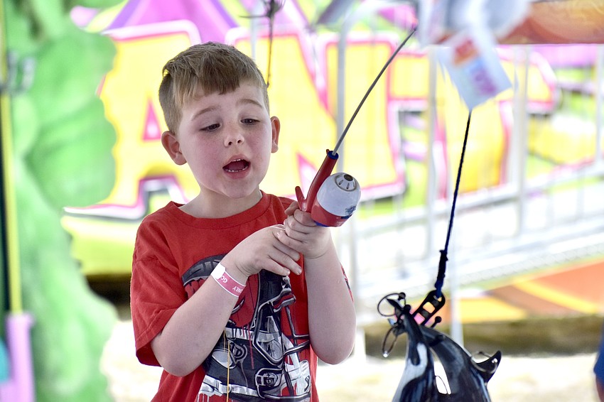 Raleigh Downing, 6, catches a toy shark.