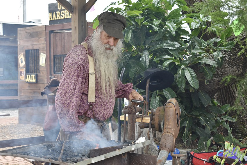 Paul Meador starts his blacksmith's fire.
