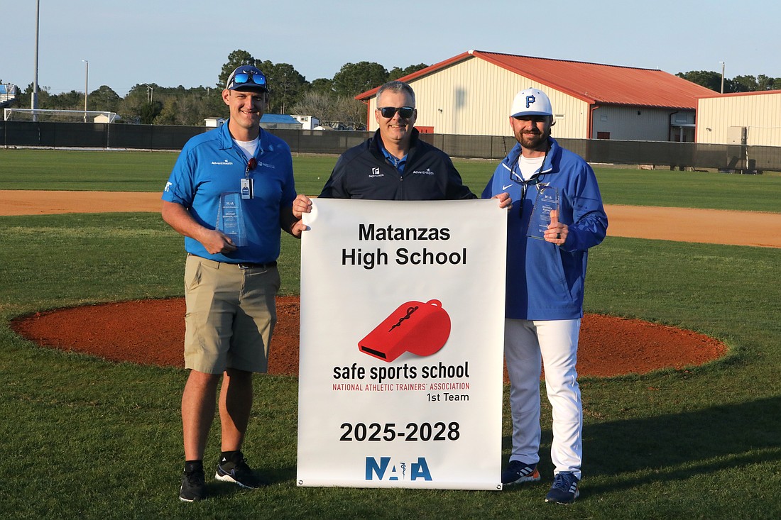 AdventHealth's Erik Nason (center) presents Matanzas athletic trainer Michael Doersch (left), an AdventHealth team member, and athletic director Zach Rigney with the Safe Sport School Award. Photo by Brent Woronoff