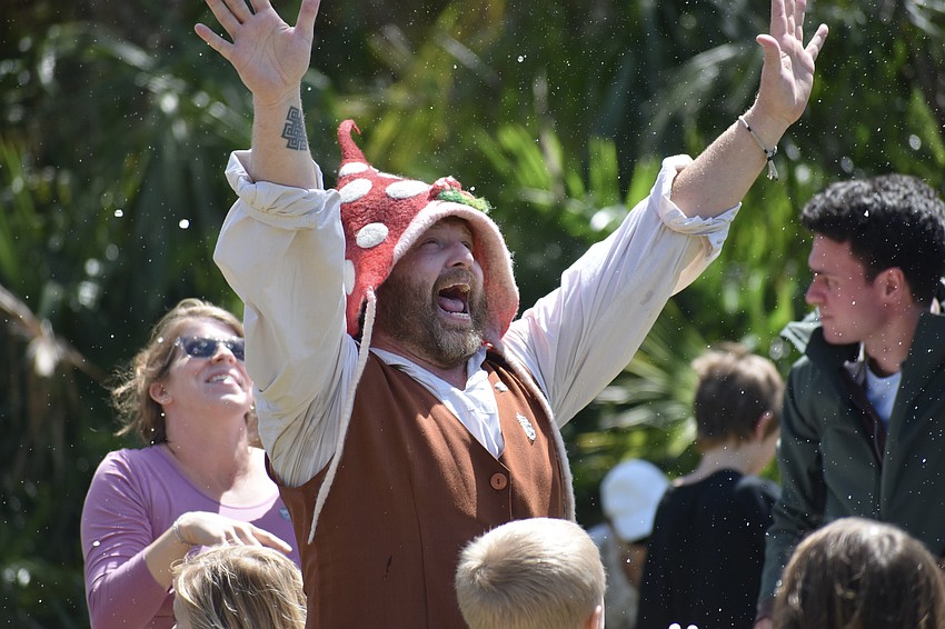 David Muirhead, dressed as a garden gnome for Selby Gardens, embraces the excitement of the bubble show.