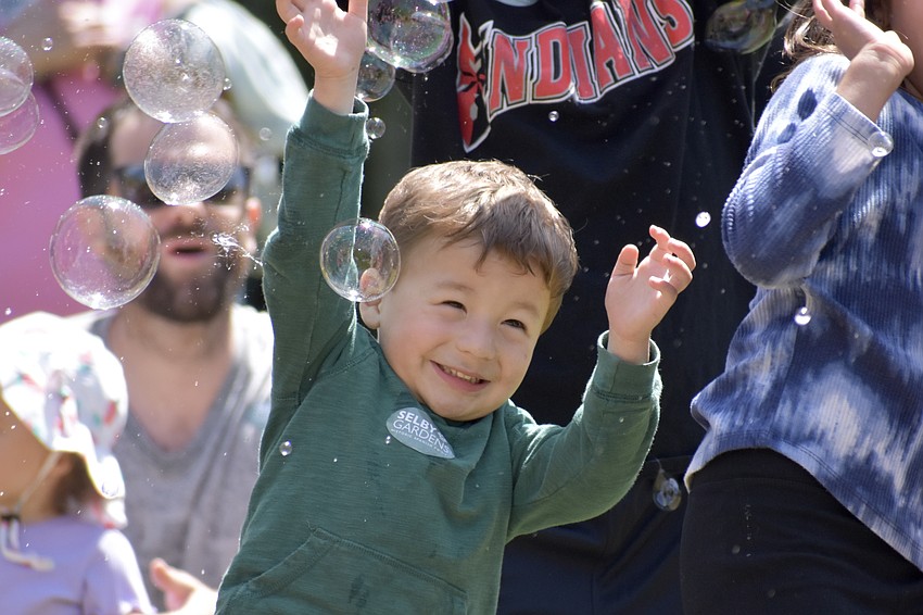 Caleb Obregon, 3, reaches for bubbles.