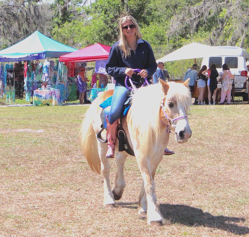 Aila Garden rides Disney around the Dag Fest grounds to promote the pony rides that were being offered.