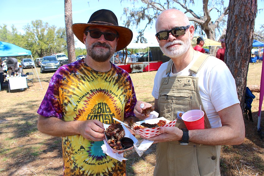 After musicians Rich Odato and Scott Hunt finished playing with Cassie Jean and the Fireflies at Dag Fest, they enjoyed some barbecue that was being sold by a food vendor.