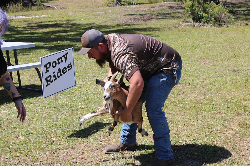 Tony Tillett of Duette caught a goat that had escaped from a petting zoo pen at Dag Fest March 22.