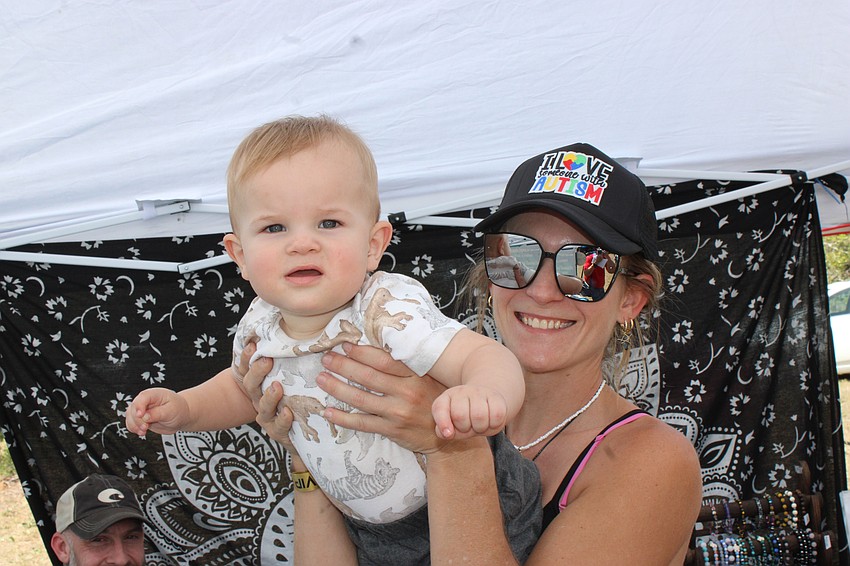 Eleven-month-old Waylon Gilmore gets a boost from his aunt, Danielle Gilmore, during Dag Fest. Danielle Gilmore ran the Seaside Spectrums booth.