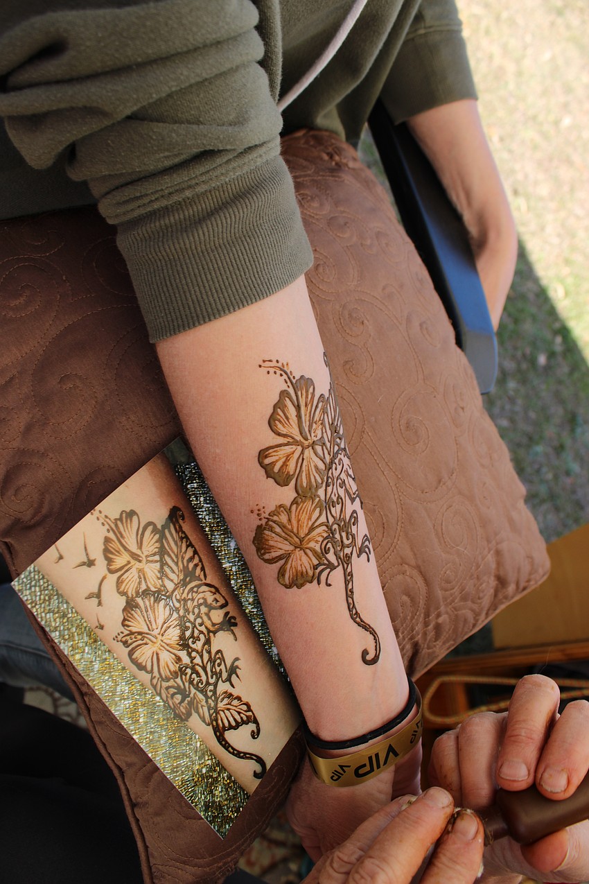 Alicia Ackerland shows off the temporary tattoo she received from Tina Berger during Dag Fest.