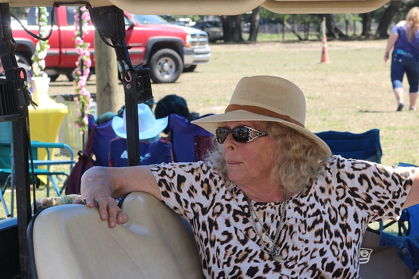 Kay Rosaire, the owner of Big Cat Habitat, makes the rounds at Dag Fest using a golf cart. Proceeds from the festival benefitted Big Cat Habitat.