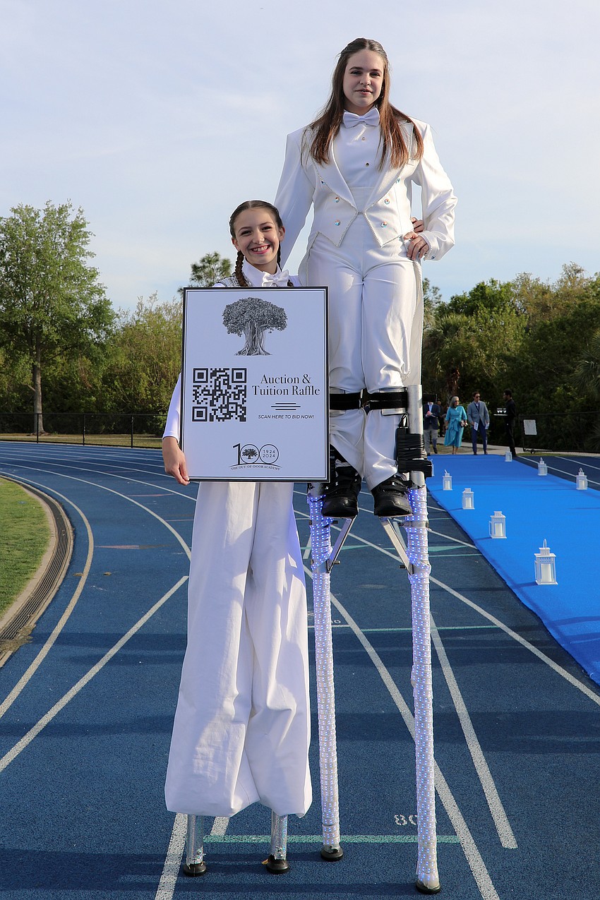 Mariah Schroeder and Jocelyn William keep guests entertained with their stilt act from Circus Arts Conservatory.