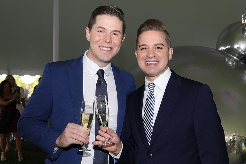 Damon Lee and Christopher Brantley enjoy the ODA Banyan Ball cocktail reception.