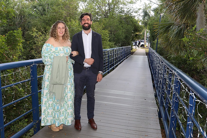 Maegan and Eric Collin cross over the ODA campus for the annual Banyan Ball held under tents on the athletic field.