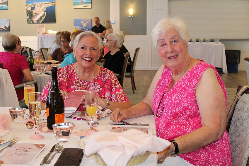Spectators Linda Beekman and Diane Koch turn out to support the fashion show fundraiser.
