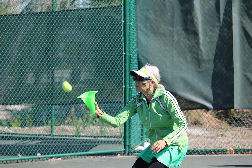 Lily Johnson races to get underneath an incoming tennis ball with her cone.