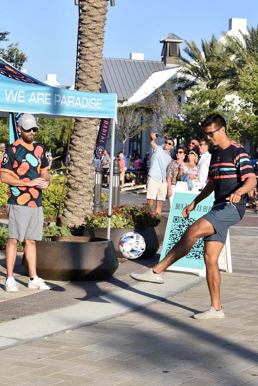 Tim Jansen, director of operations for the Sarasota Paradise soccer team, and player Seth Heiland entertain the crowd with a soccer ball.