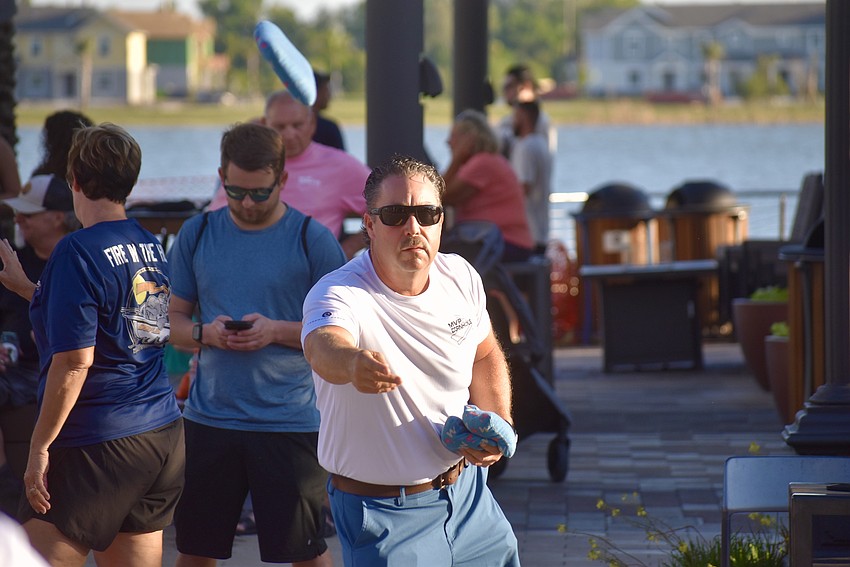 East County's Seth Heiland launches a bean bag during a game of cornhole.