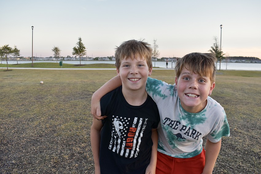 Rugby players Odin LeRoux, 9, and Tucker Holowaychuk, 10, goof off in between drills.
