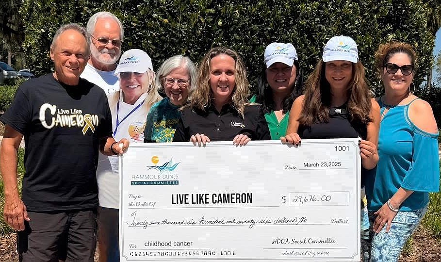 Members of the Hammock Dunes Social Committee with the jumbo check to Live Like Cameron Board member Melisa Fulling. From left, Mike Hayek, Brian Kargel, Kelly Pirrello, Nancy Geisler, Melisa Fulling, Joyce Casis, Lisa Fisher and Rosie Del Rosario. Courtesy photo