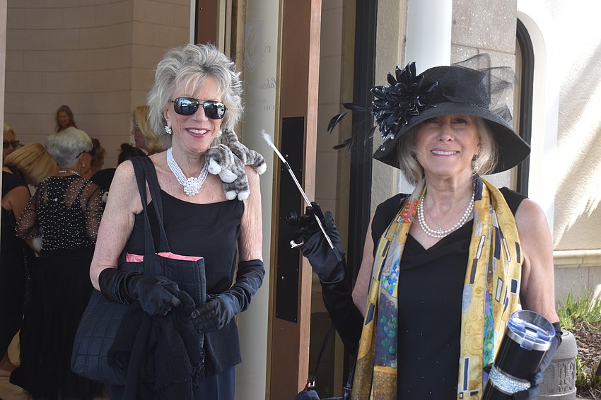 Laurie Zelen shows off a furry friend on her shoulder as she arrives at Divas and Dogs along with Dianne Frestel.