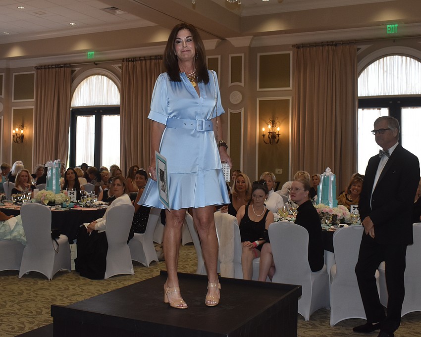 Model Suzy Wojcik goes above the crowd to model a fashion at Divas and Dogs.