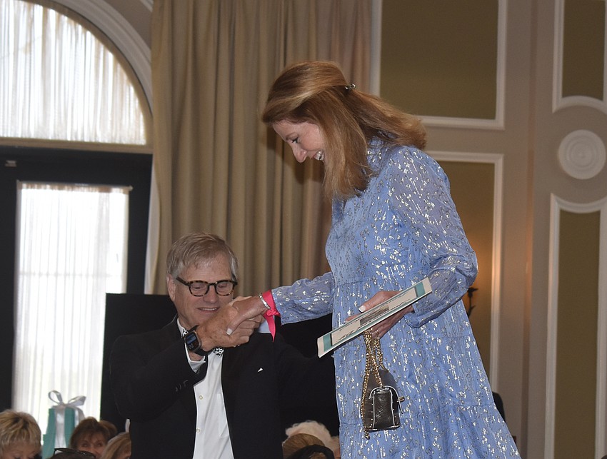 Jeff Nicholas gives Denise Little a helping hand after her turn as a fashion model during Divas and Dogs.