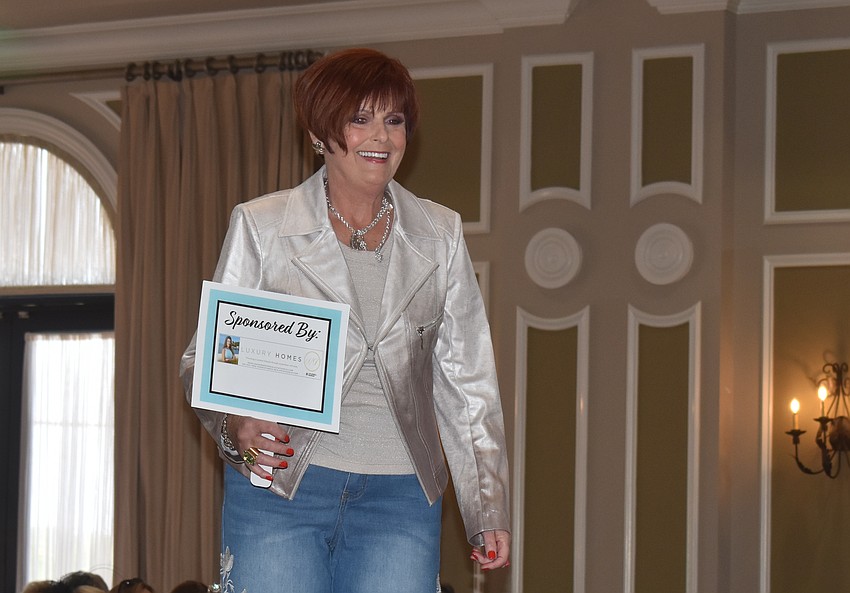 Model Cathy Adragna walks the runway during the Divas and Dogs fashion show.