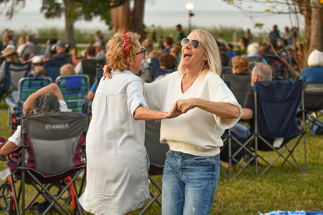 Shannon Phillips, left, and Tracey Morrissey danced on the lawn of Newton Park during the Evening at the Pops concert.