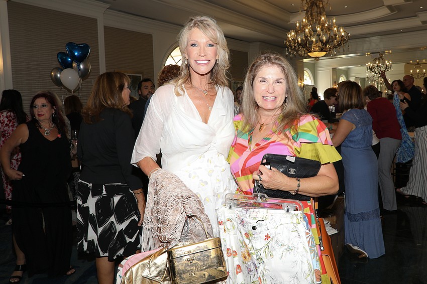 Dawn Spencer and Geri Waksler wait in the checkout line at the SPARCC luncheon held March 28.