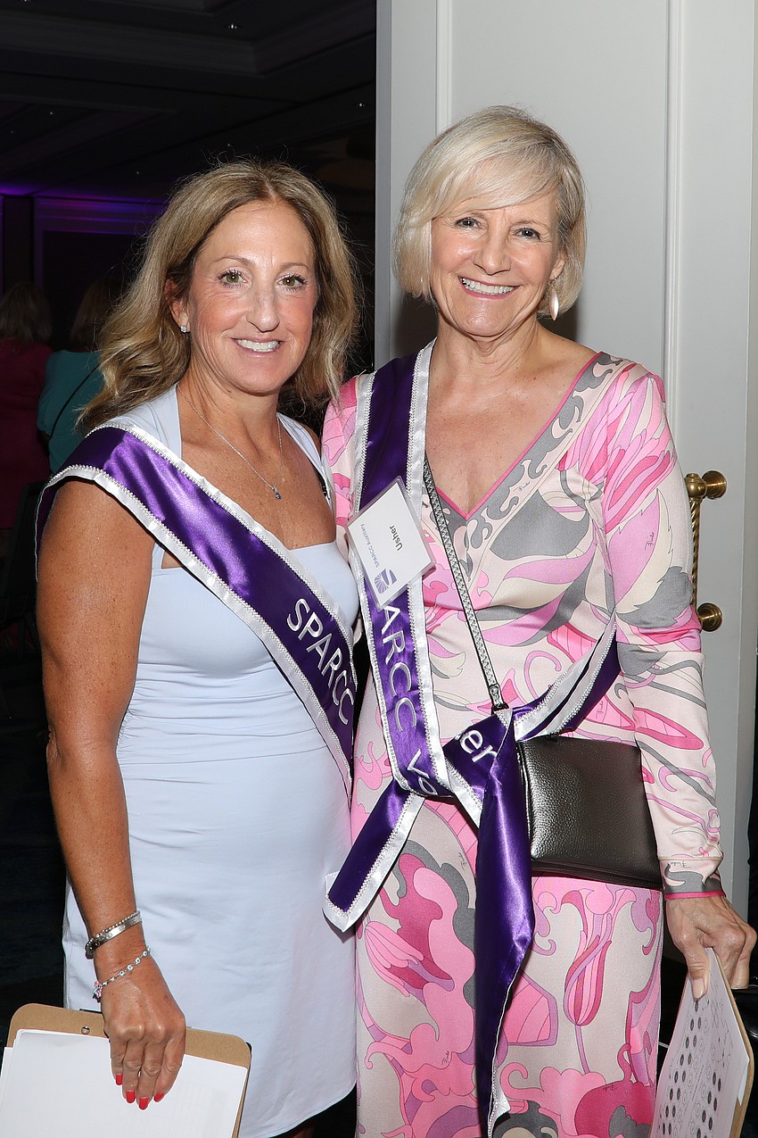 Acting as ushers for the day, Jackie Frank and Colleen Curran direct people to their luncheon tables.
