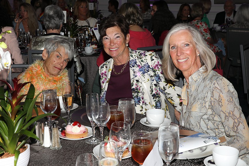 Mercedita Oconnor, Joanne Heisen and Vera Koehler enjoy the fashion show during lunch.