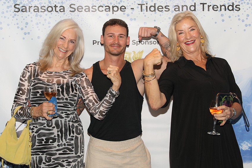 Sharyl Smith and Laura Leeming show off some muscle with their personal trainer and volunteer SPARCC Runway model, Jamie McGraw.