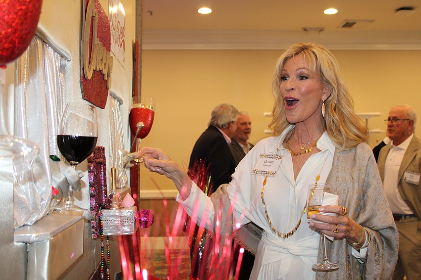 Dawn Spencer gets surprised at the wine wall.